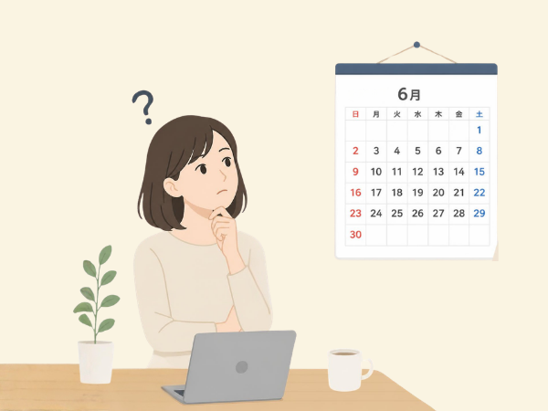 6月の壁のカレンダーを見ながら何日前に予約しようか?と考えている女性